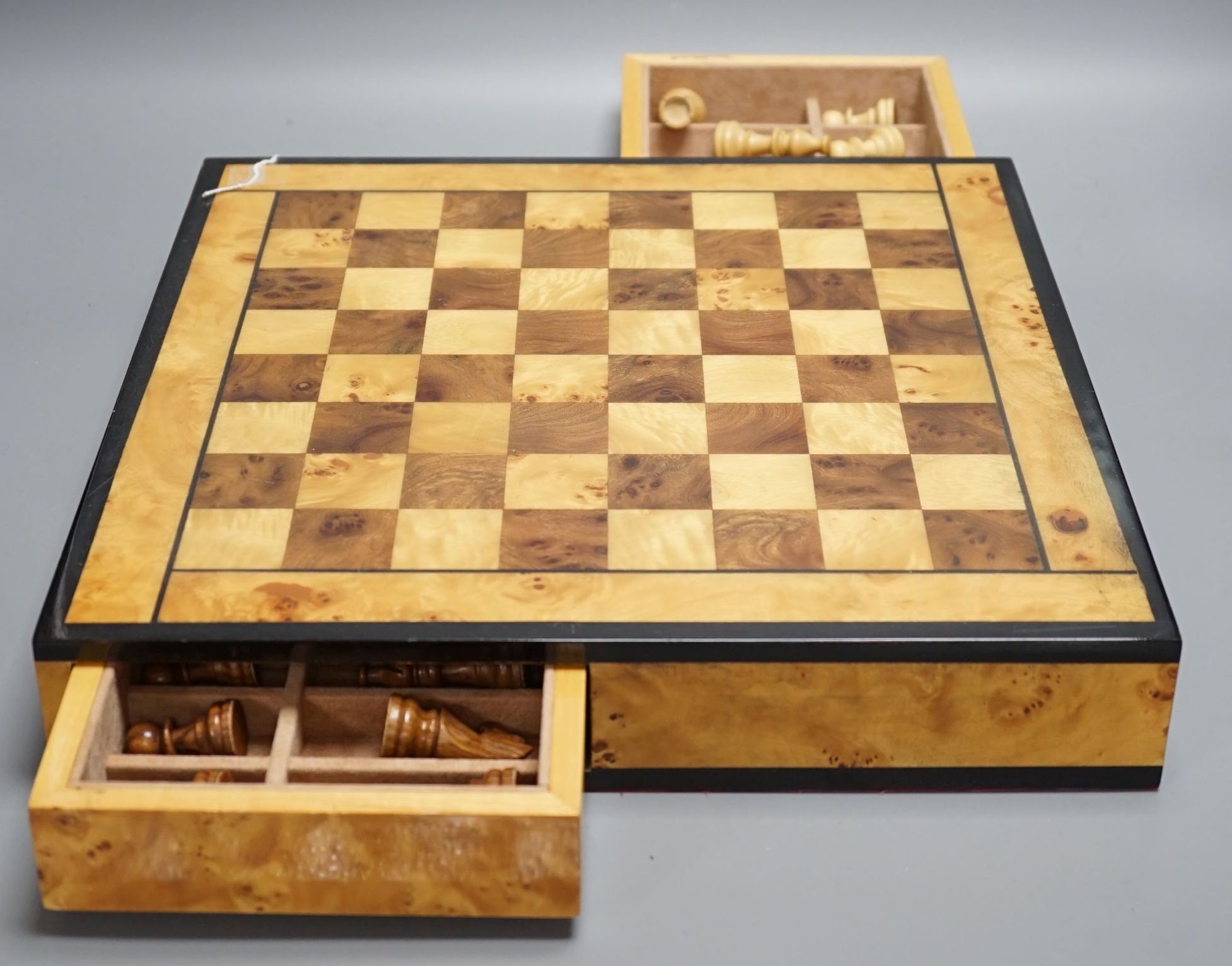 A cased Backgammon set and a chess set with chess-board top and drawers for chess pieces, chess box 35.5 cms x 35.5 cms.